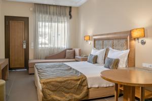 a hotel room with a bed and a table at Danai Hotel & Spa in Olympic Beach