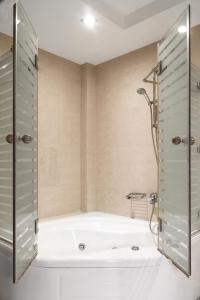 a bathroom with a bath tub and a shower at Danai Hotel & Spa in Olympic Beach