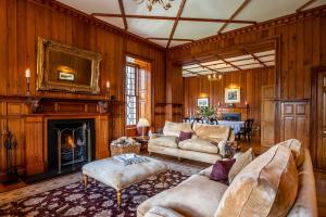 a living room filled with furniture and a fireplace at Assynt House 5 Star Exclusive Use Venue in Dingwall