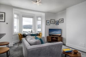 a living room with a couch and a television at Oakdene in Deganwy