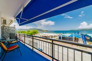 a balcony with a view of the beach at Upper Deck Apt. in Nea Peramos