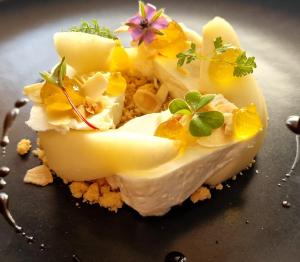 a piece of cheese with flowers on top of it at Locanda La Cavallina in Brisighella
