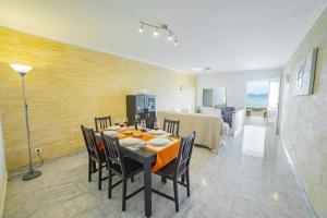 a dining room with a table and chairs and a kitchen at Coastal House Sa Fortalesa in Alcudia in Alcudia