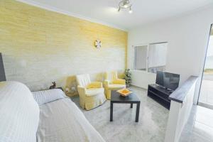 a living room with a bed and a couch and a tv at Coastal House Sa Fortalesa in Alcudia in Alcudia