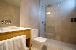 a bathroom with a shower and a toilet and a sink at Teide Rooms in Puerto de Sagunto