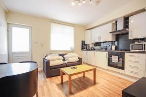 a living room with a couch and a table at Camden Town apartments in London +24 photos
