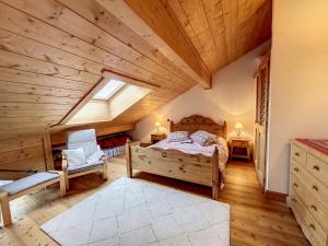 a bedroom with a bed and a wooden ceiling at Bells Lodge in Chamonix