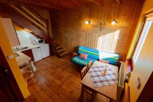 a living room with a blue couch and a table at Apartamenty Rodzinne Łukęcin in Łukęcin