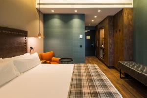 a hotel room with a bed and a couch at Catalonia Donosti in Donostia-San Sebastián
