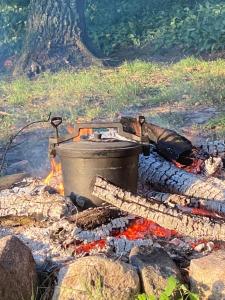 a pot sitting on top of a camp fire at Letnisko BAJKA in Iława +201 photos