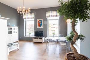 a dining room with a table and a potted plant at Apartment Wilhelmine in Borkum