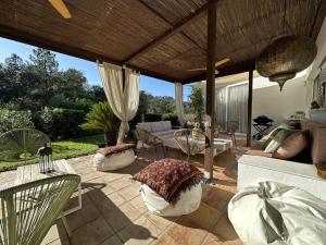 a patio with couches and a table and chairs at Villa Glamour in Santa Cristina d'Aro