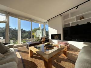 a living room with a large television and a table at Villa Glamour in Santa Cristina d'Aro
