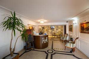 a lobby with a potted plant and a waiting room at Hotel Art in Buzau