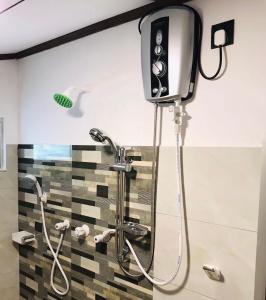 a shower in a bathroom with a shower head at Coastal House in Mirissa