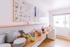 a kitchen with a long counter with plates and utensils at Eldá apartments in Myvatn