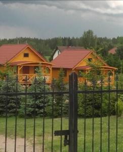 a house with a fence in front of it at Siedlisko u Agi in Ryn