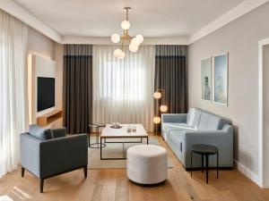 a living room with a couch and chairs and a table at Lara Barut Collection-Ultra All Inclusive in Lara
