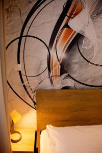 a close up of a bedroom with a painting on the wall at Apartment Latte in Budapest