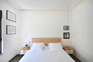 a bedroom with a large white bed with white sheets at Luna Moona by HolyGuest in Tel Aviv