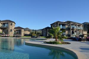 a resort with a swimming pool in front of some buildings at Niki Luxury Apartments Niki Suites Petra in Petra