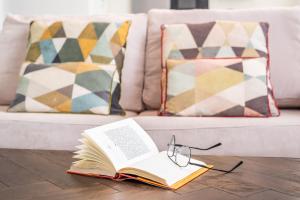 a book and glasses on a coffee table in front of a couch at Moderno Apartamento in Marbella