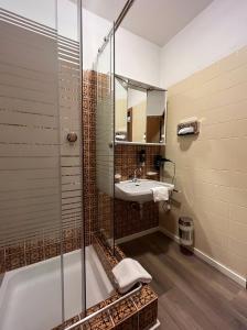 a bathroom with a shower and a sink at Bel'vue in Lienz