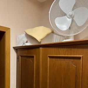 a fan on top of a wooden cabinet at Bel'vue in Lienz