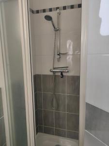 a shower with a shower head in a bathroom at chambre avec SDB privative en pleine campagne in Baillou