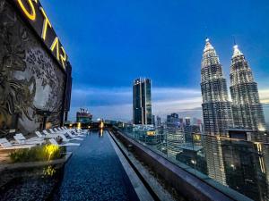 a view of the petronas twin towers from the roof of a building at AXQUISITE SUITES at KLCC in Kuala Lumpur