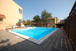 a swimming pool in the middle of a house at Delta Blu Residence Village in Lido di Pomposa