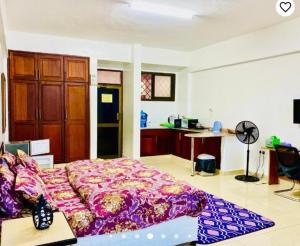 a bedroom with a bed and a kitchen at Queens Rentals - Studio Apartments - Village Walkway - Masaki - Dar es Salaam in Dar es Salaam