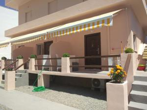 a house with a bench in front of it at Aphrodites Apartments in Kini