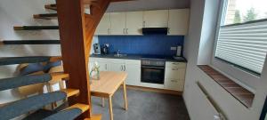 a small kitchen with a wooden table in a room at Ferienwohnung in Bad Segeberg