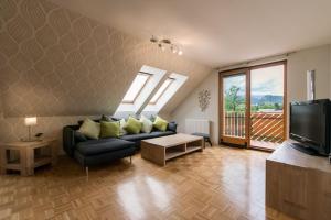 a living room with a couch and a tv at Sava View 8 in Ribno