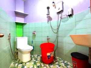 a bathroom with a toilet and a sink at Evan's Homestay in Basco