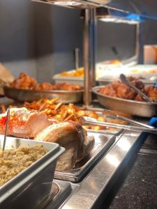 a buffet line with meat and other food items at Bushwood-Beautifully Fitted Wooden Lodge Helston Cornwall in Helston