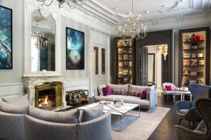 a living room with couches and a fireplace at Hôtel Mont-Blanc Chamonix in Chamonix