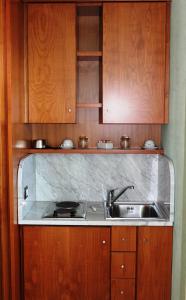 a kitchen with a sink, stove, and cabinets at Villa Ersilia in Soverato Marina