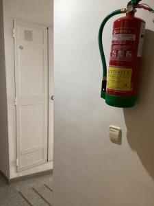 a fire hydrant hanging from a wall next to a door at Fuengirola Holidays Sun & Beach in Fuengirola +47 photos