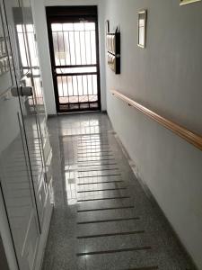 an empty hallway with a door and a stairway at Fuengirola Holidays Sun & Beach in Fuengirola