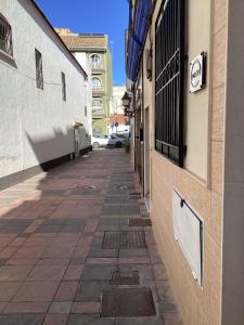 an empty street in a city with a building at Fuengirola Holidays Sun & Beach in Fuengirola