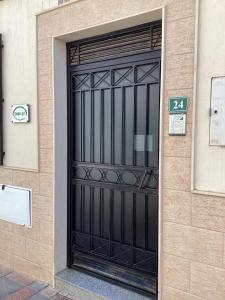 a black door on the side of a building at Fuengirola Holidays Sun & Beach in Fuengirola