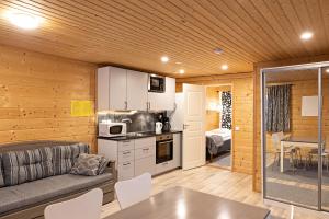 Arctic River Resort في إيفالو: مطبخ وغرفة معيشة مع أريكة وطاولة