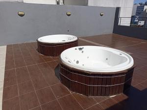 2 bañeras de hidromasaje en un suelo de baldosa en una habitación en san telmo sos hermoso en Buenos Aires
