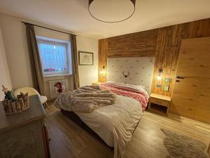 a bedroom with a bed with a blanket on it at Val Gardena in Selva di Val Gardena