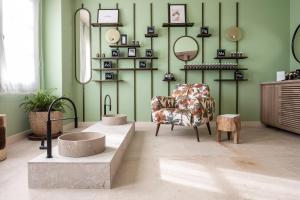 a room with a chair and mirrors on the wall at Kimpton Aysla Mallorca by IHG in Santa Ponsa