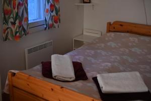 a bedroom with a bed with two towels on it at Hostel Ukonlinna in Imatra