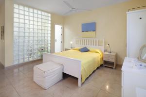 a bedroom with a bed with a yellow blanket at Casita Linda in Cómpeta +20 photos