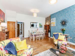 a living room with a couch and a table at Central Tod Cottage in Todmorden